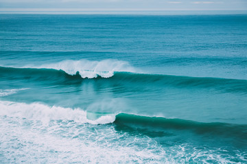 Crashing big wave in ocean and cloudy weather. Swell for surfing