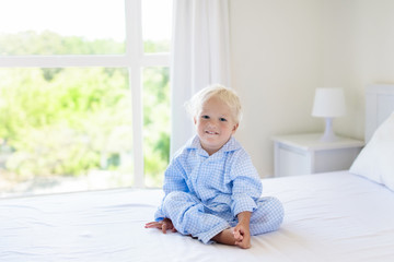 Kids in bed. Children in pajamas. Family bedroom.