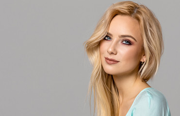 Portrait of blond female model with blue eyes
