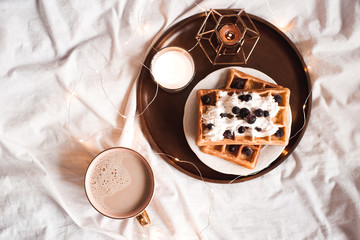 Cup of coffee with homemade waffles closeup. Good morning. Selective focus.