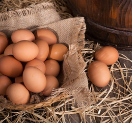 Brown Eggs in a Basket on a Straw Covered Surface