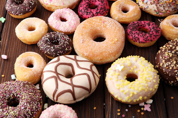 assorted donuts with chocolate frosted, pink glazed and sprinkles donuts.