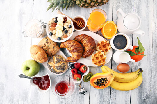 Breakfast served with coffee, orange juice, croissants and fruits. Balanced diet.