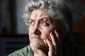 Frowning and sad elderly woman face