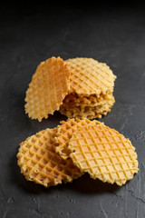 round fresh waffle pile on a dark background