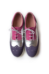 Top view of violet, silver and pink women oxford shoes, isolated on white background