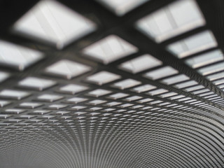 A stainless steel perforated sheet metal, a stainless steel square screen in the background.