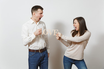 Young couple in love. Man and woman with wooden word Love isolated on white background. St. Valentine's Day International Women's Day birthday holiday concept. Quarrel divorce break up of relationship
