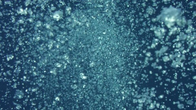 Rising bubbles with light reflections underwater, Indonesia, slow motion