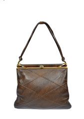 Vertical shot of the front of a vintage brown crisscross pattern purse hanging by the strap isolated on white.