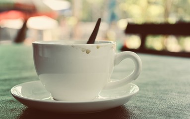 Dirty cup of coffee on table in cafe ,Morning light
