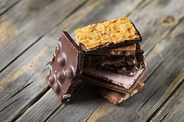 Mix of sweet swiss choccolate on the wooden table