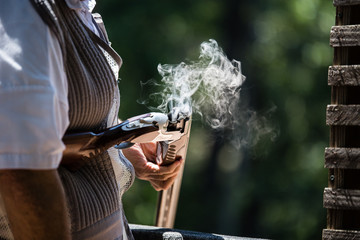 Man holding smoking gun © Andrea