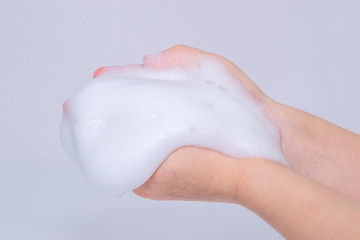 Foam of soap or shampoo on female hands