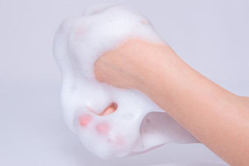 Fototapeta premium Foam of soap or shampoo on female hands