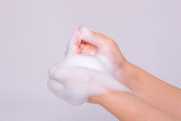 Foam of soap or shampoo on female hands