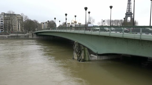 Paris,France-January 23, 2018: Paris people measure the risk of flood by monitoring which part of the statue the water reaches. Current warning level is not red.