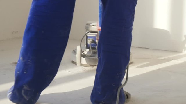 Man Polishing Marble Floor In Modern Office Building. Man Works With Grinding Machine For Floor