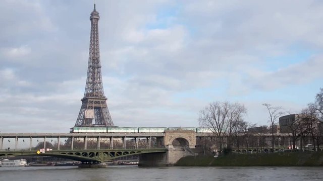 Metro crossing Passy bridge with Eiffel Tower in background - Paris, France