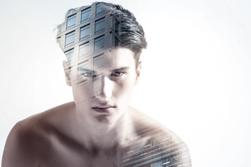  No limits. Ambitious cute creative guy thinking beyond stereotypes while standing on the isolated...
