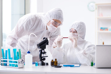 Two chemists working in the lab