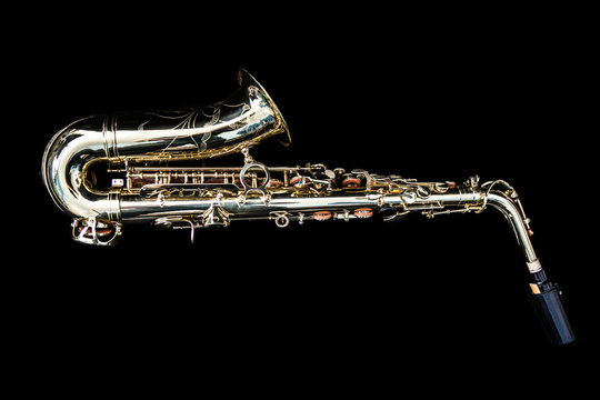 Full view of a golden saxophone lying down
