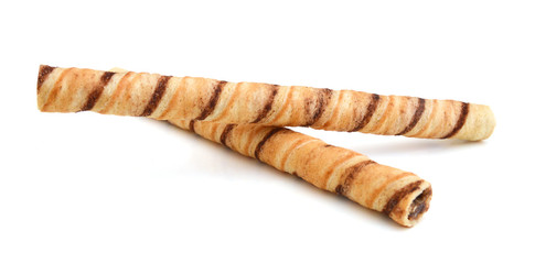 Heap of striped wafer tubules with the chocolate cream; isolated