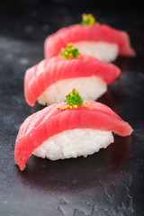 Three Sushi nigiri with tuna on black background