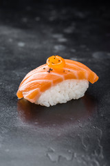 Sushi nigiri with salmon on black background