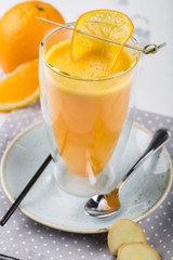 A glass of tea with orange and ginger