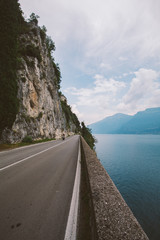 Driving on a scenic road along Lake Garda, Italy. Summer time. European vacation, living, life style, architecture and travel concept