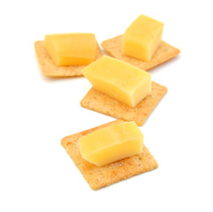 Delicious crackers with cheese on white  background