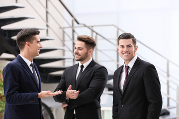 Men in elegant suits at workplace