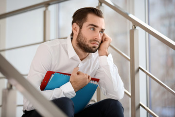 Young man being bullied at work