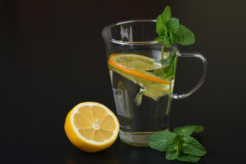 still life of fresh fruits and herbs on a dark background close up