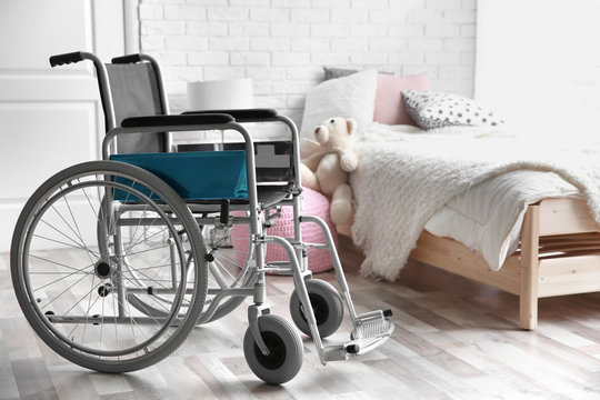 Empty wheelchair in children's bedroom