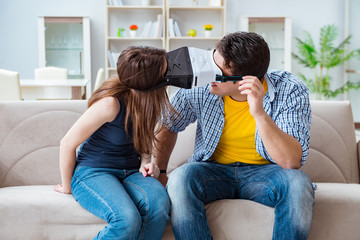 Young family playing games with virtual reality glasses