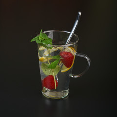 still life of fresh fruits and herbs on a dark background close up