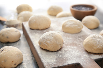 Fototapeta na wymiar Unbaked buns of dough on table
