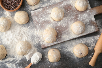 Unbaked buns of dough on table