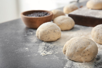 Fototapeta na wymiar Unbaked buns of dough on table