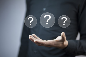 Man touching question mark in screen