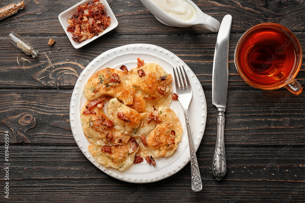 Wall mural Plate with tasty dumplings served on table