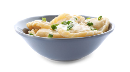 Bowl with tasty dumplings on white background