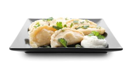 Plate with tasty dumplings on white background
