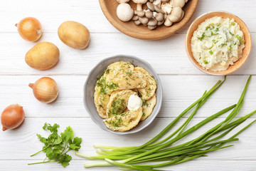 Bowl with tasty dumplings on wooden background