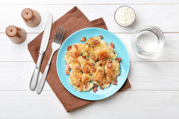 Plate with tasty dumplings served on table