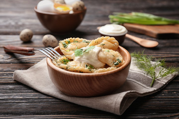 Bowl with tasty dumplings on table