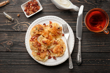 Plate with tasty dumplings served on table