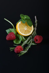 still life of fresh fruits and herbs on a dark background close up